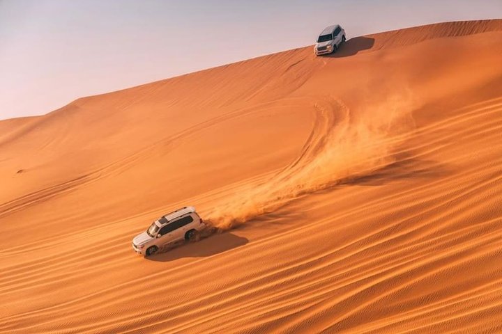 Dubai Desert safari 4x4 Dune Bashing, Sandboarding, Camel Riding, Bbq Dinner  - Image 1