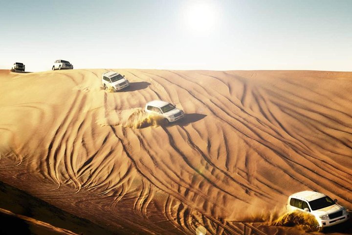 Dubai Desert Safari With BBQ Dinner, Camel Ride, Belly Dancing and sandboarding - Image 1
