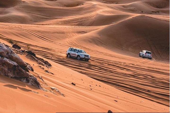 Dubai Desert Safari With BBQ Dinner, Camel Ride, Belly Dancing and sandboarding - Image 4