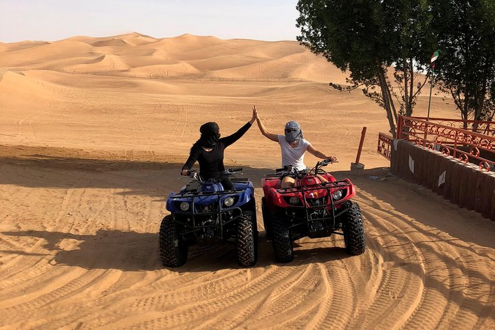 Dubai: Unique SUNSET Quad Bike Red Dunes Safari  - Image 1