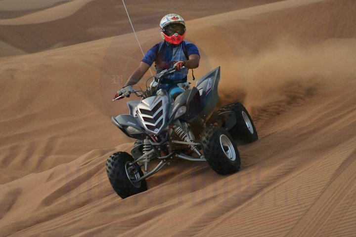 Dune Bashing with Quad Bike and Sand Boarding from Dubai - Image 1