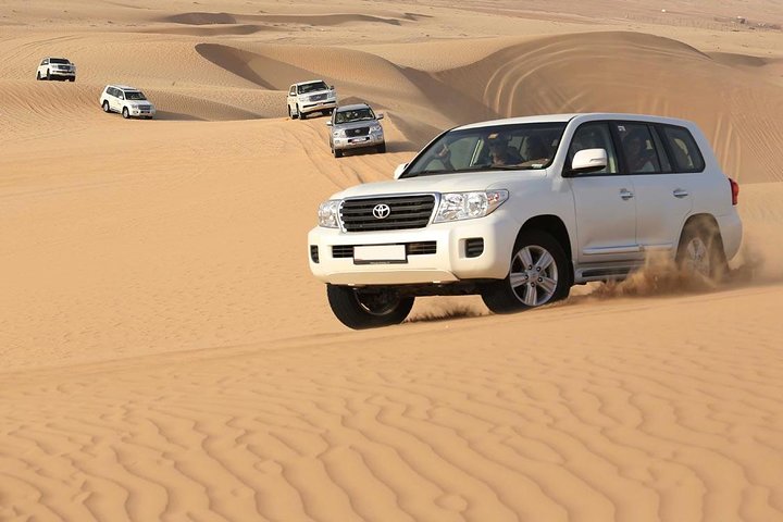PRIVATE Dubai Desert Safari with BBQ Dinner, Camel Ride, Sand boarding & Shows - Image 2