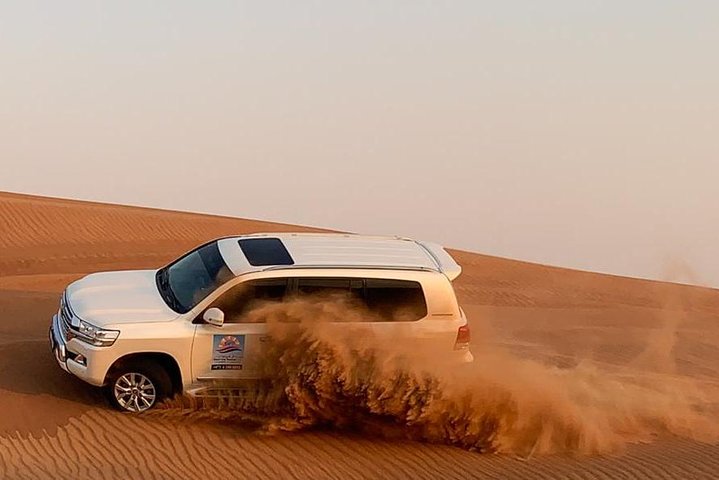 Private Evening Desert safari with BBQ Dinner, Camel Ride, Sand Boarding  - Image 1