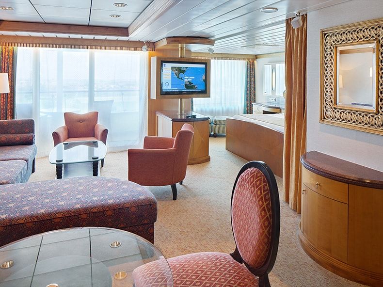 Adventure of the Seas Owner's Suite - 1 Bedroom (OS) living area, photo 1 of 4