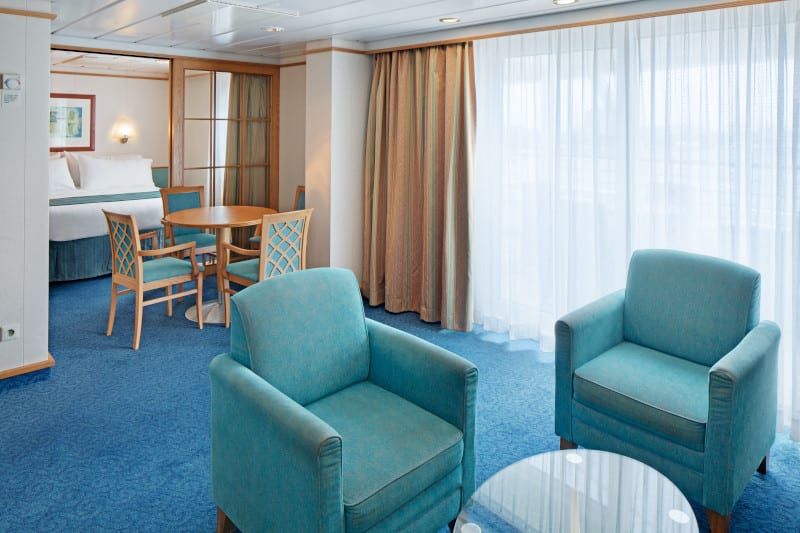 Adventure of the Seas Grand Suite - 2 Bedroom (GT) living area, photo 3 of 4