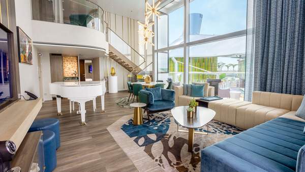 Icon of the Seas Royal Loft Suite (RL) living area, photo 1 of 9