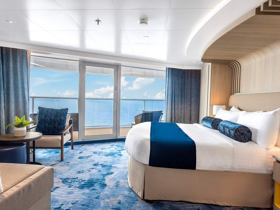Icon of the Seas Sunset Corner Suite (SN) bedroom, photo 1 of 7