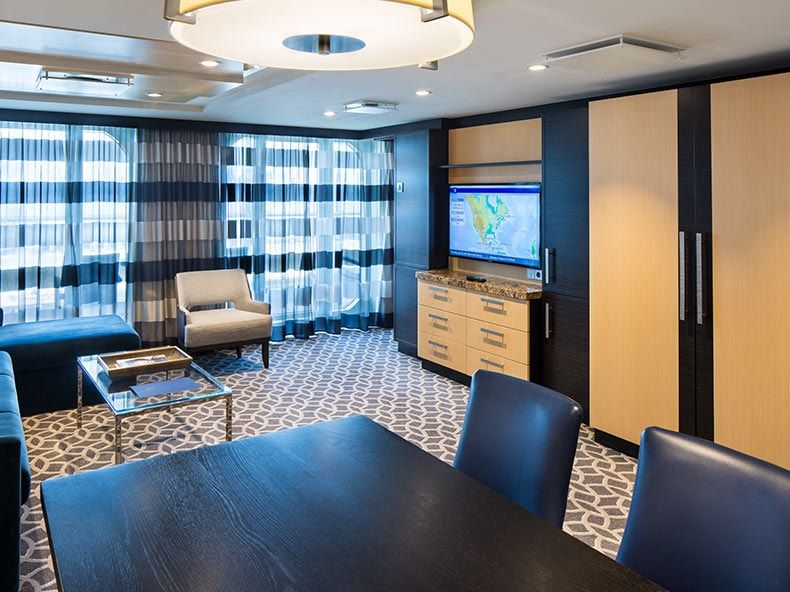 Odyssey of the Seas Owner's Suite - 1 Bedroom (OS) living area, photo 1 of 5
