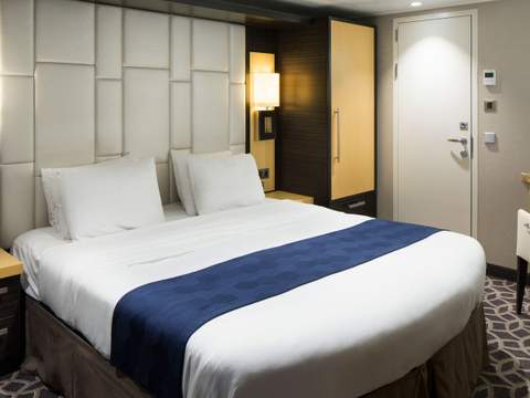 Odyssey of the Seas Owner's Suite - 1 Bedroom (OS) bedroom