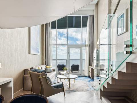 Utopia of the Seas Crown Loft Suite (L1) living area, photo 1 of 5