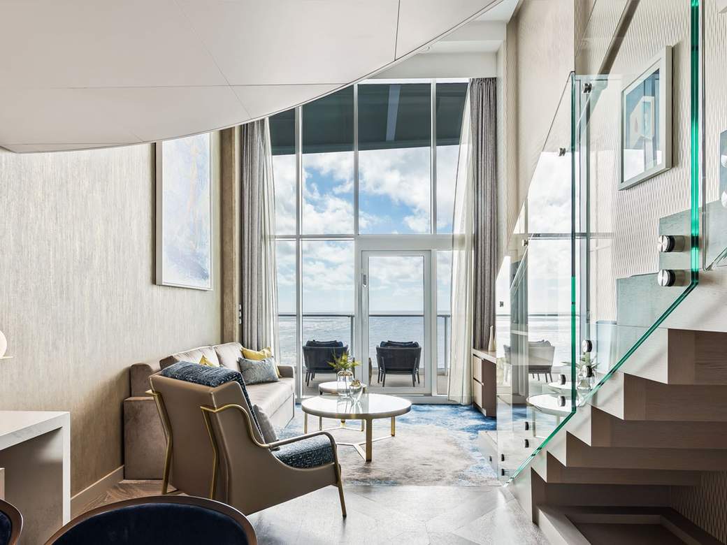 Utopia of the Seas Crown Loft Suite (L1) living area, photo 1 of 5