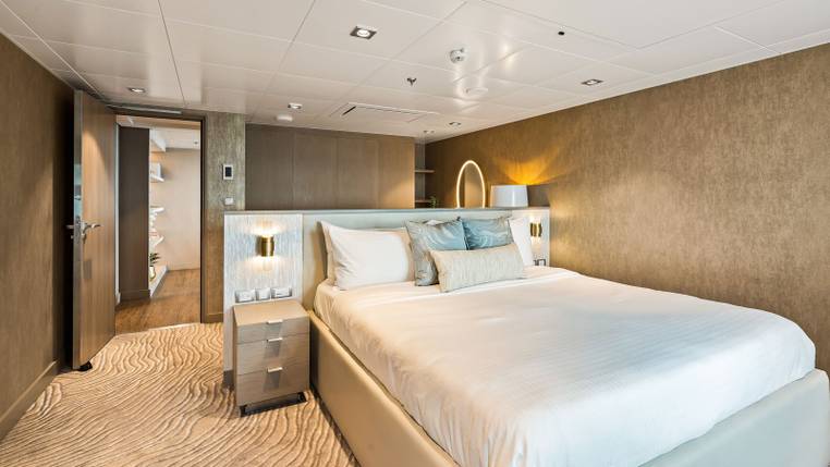Utopia of the Seas Royal Loft Suite (RL) bedroom, photo 3 of 4